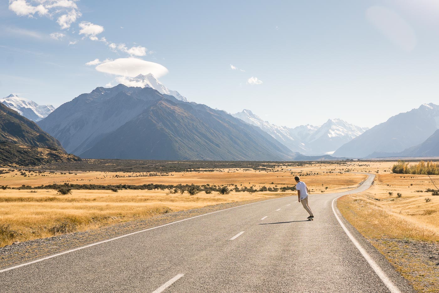 Stefan Haworth skating down the road to Mount Cook National Park.