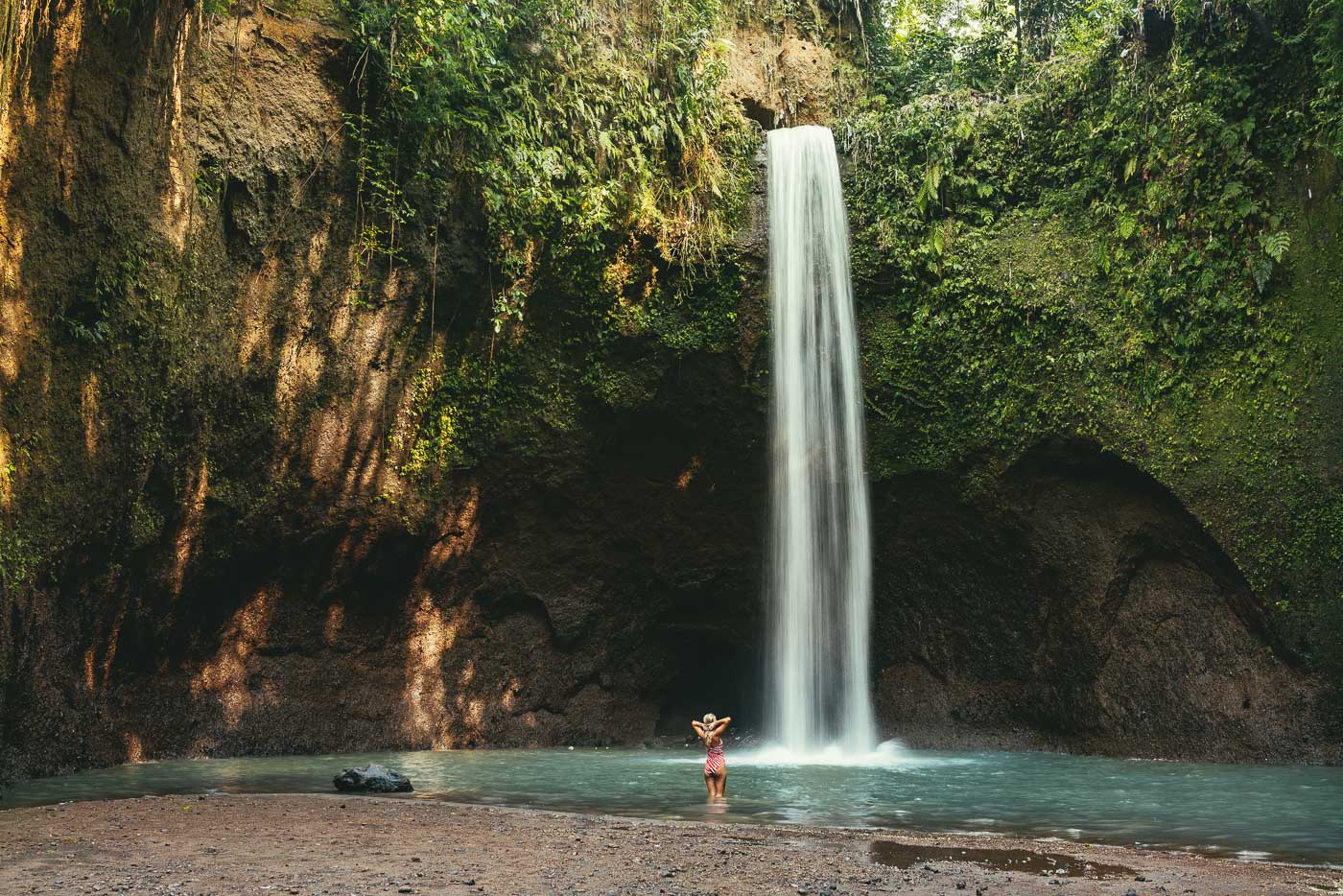 Lauren Bullen about to dip into refreshing pools underneath waterfall in Bali. Photo by Sony Ambassador Stefan Haworth