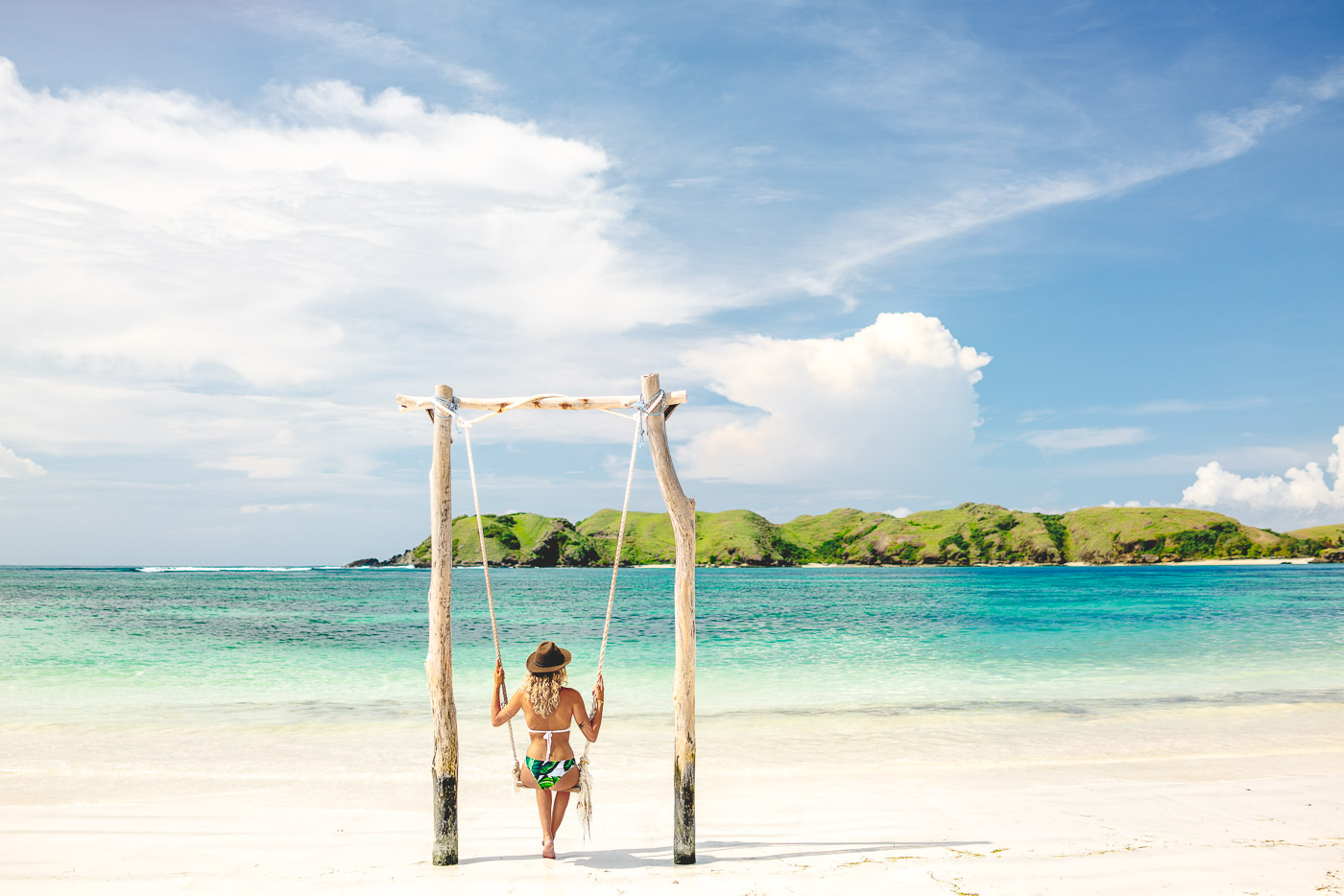 Annie swinging over tropical waters in Kuta Lombok. Photo by Sony Ambassador Stefan Haworth