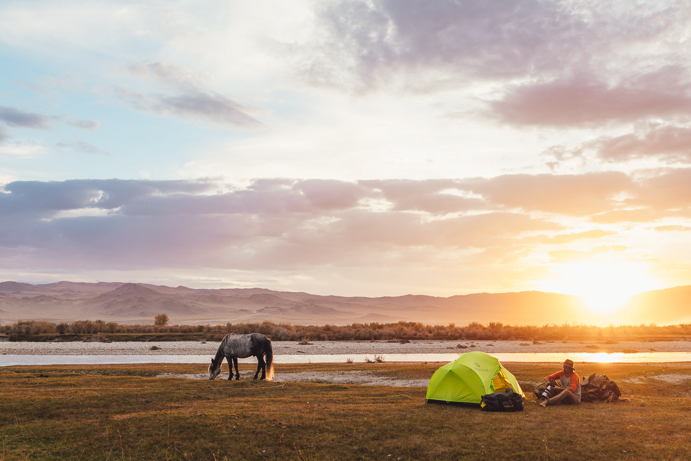 Stefan Haworth camping on a solo horse trekking expedition in Mongolia at sunset