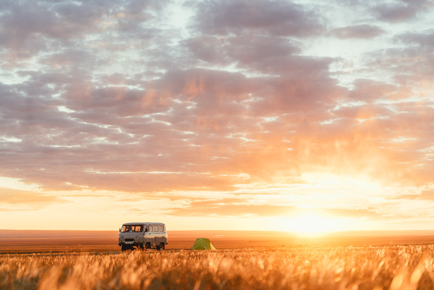 sunrise over the van and tent in Mongolia