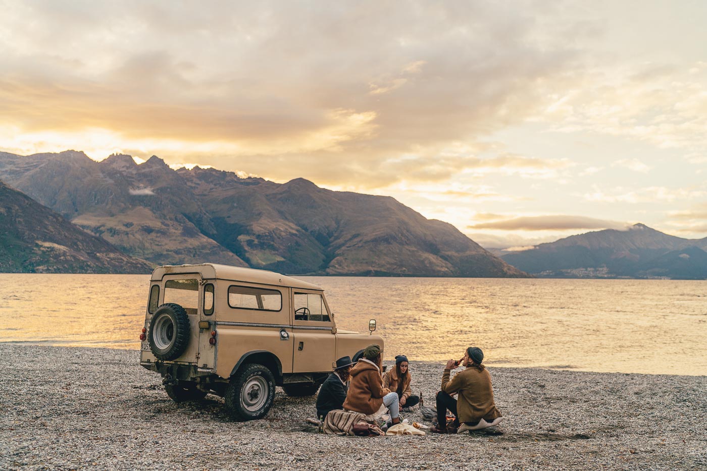 Enjoying beers next to a land rover at sunset in Queenstown, New Zealand