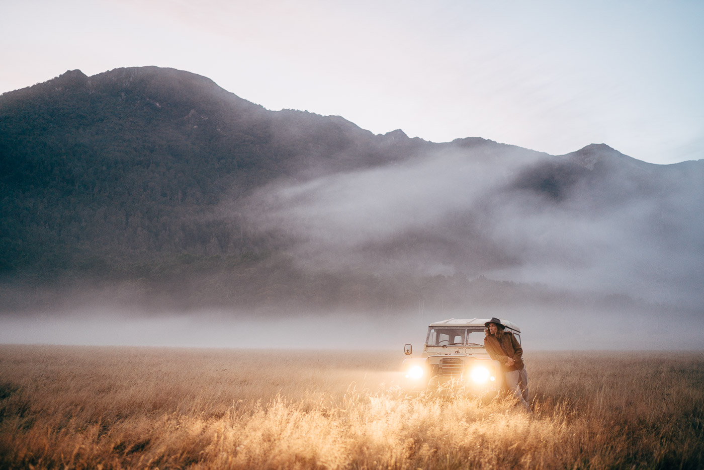 Land Rover in a grass field in the fod of Fiordland, New Zealand