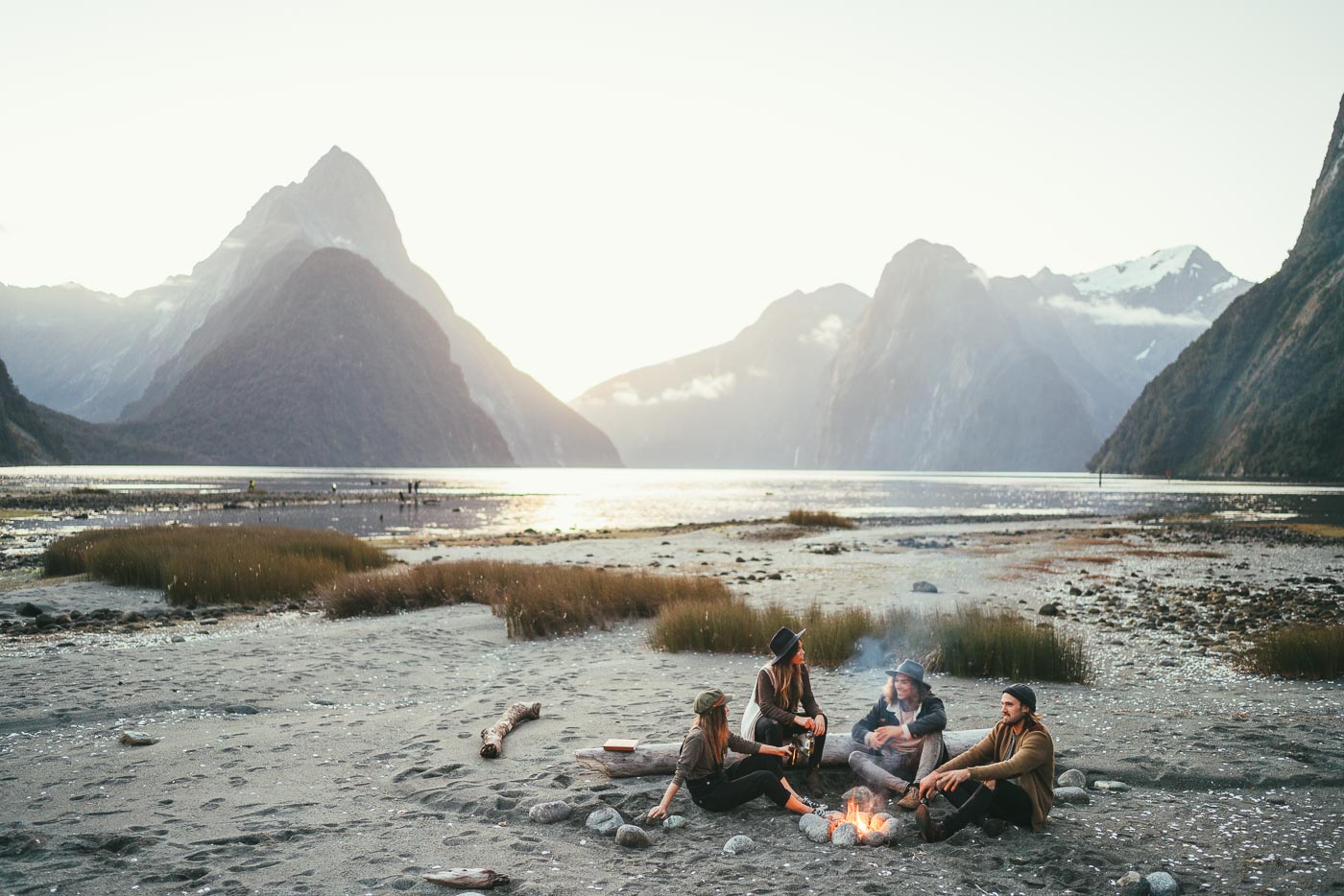 Friends having a campfire at Milford Sound, New Zealand