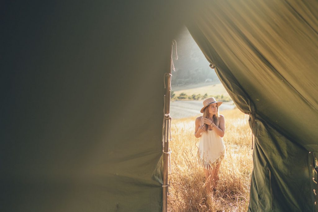 Lauren Willliamson in long grass in New Zealand on the Will and Bear Road trip