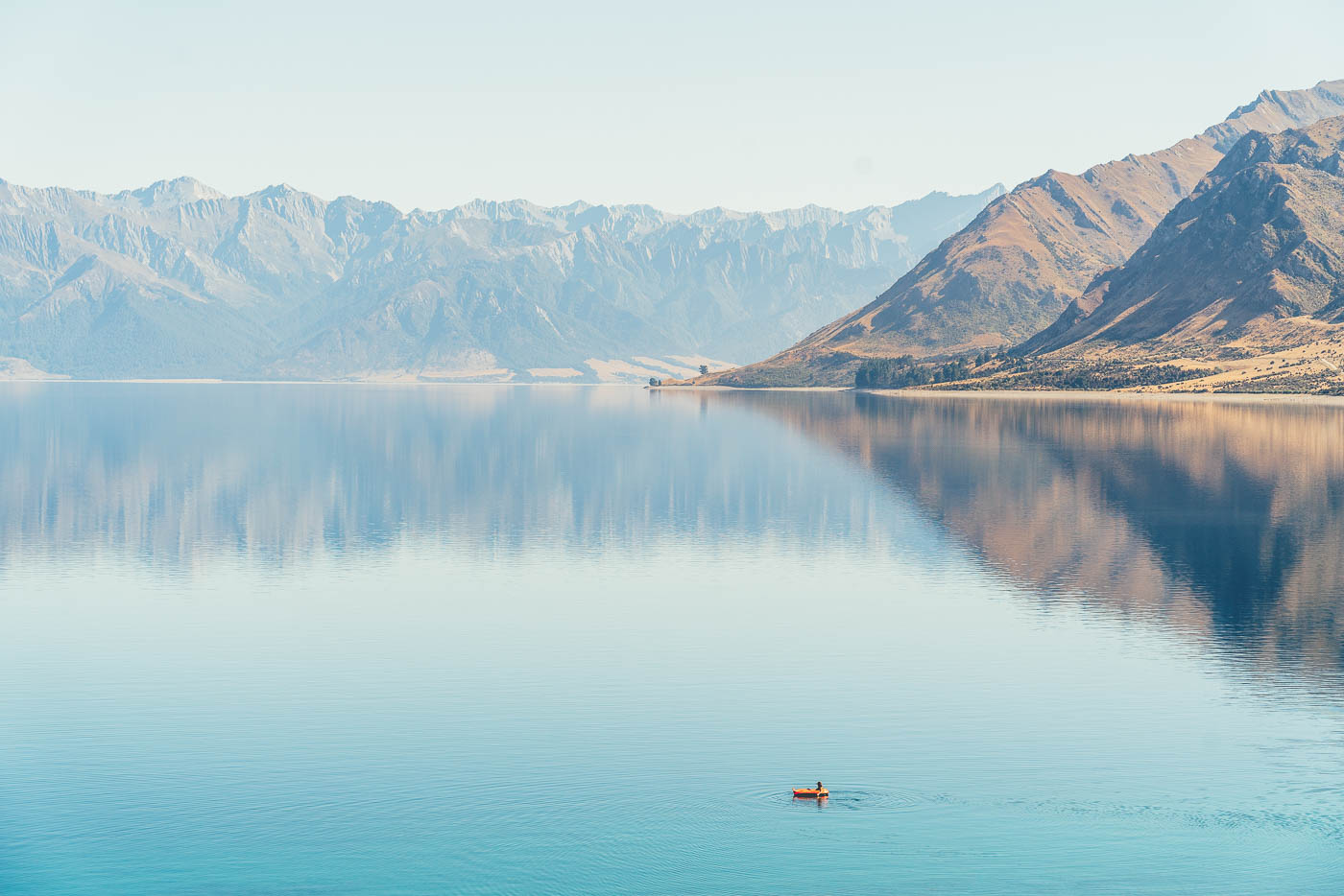 Floating across Lake Hawea in New Zealand on the Will and Bear Road trip