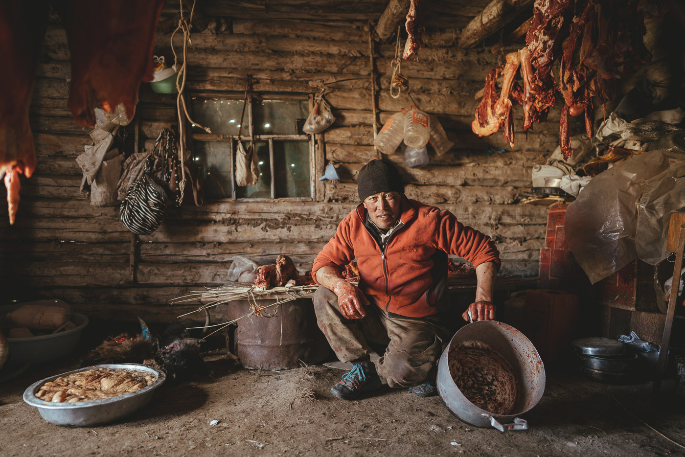 Mongolian farmer with bloody hands in the meat storage room in Mongolia. Captured by Sony ambassador and photographer Stefan Haworth