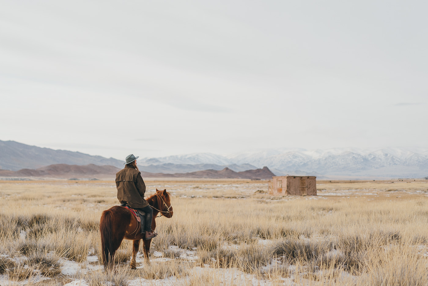 Adventure photographer Stefan Haworth on horseback during a winters day in the western Mongolian Mountains.