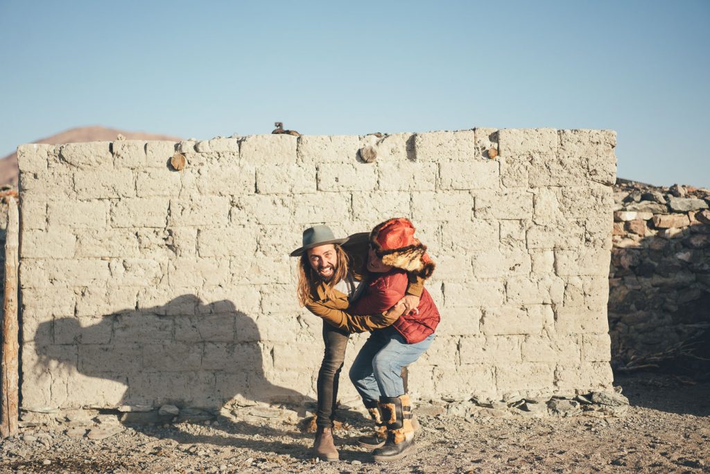 Adventure photographer Stefan Haworth wrestling with friend and Mongolian farmer in Mongolia/