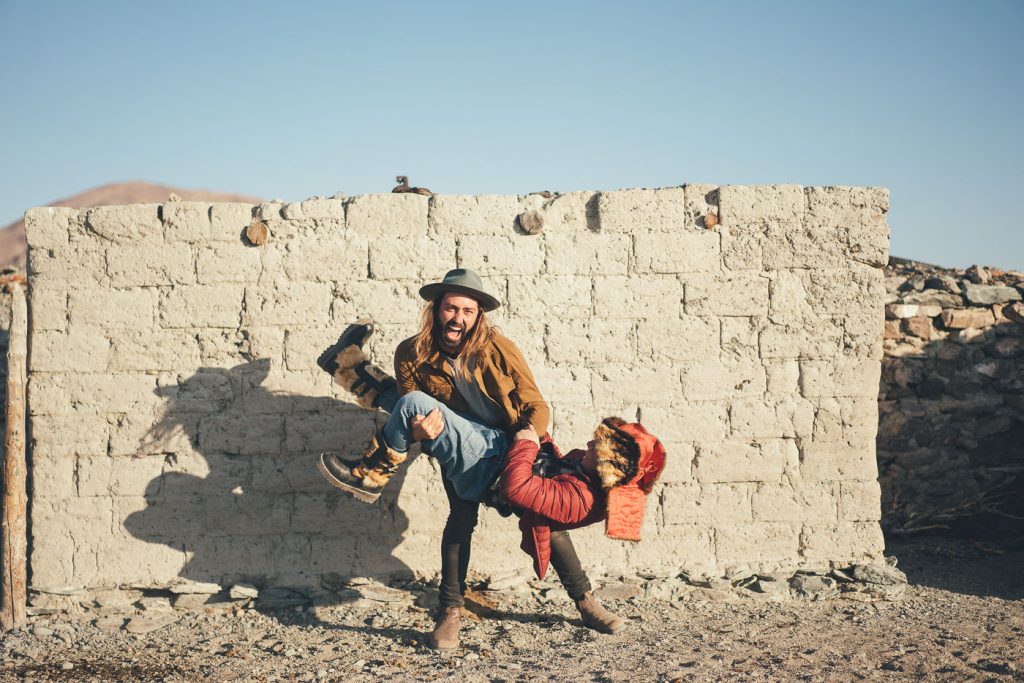 Adventure photographer Stefan Haworth wrestling with friend and Mongolian farmer in Mongolia.