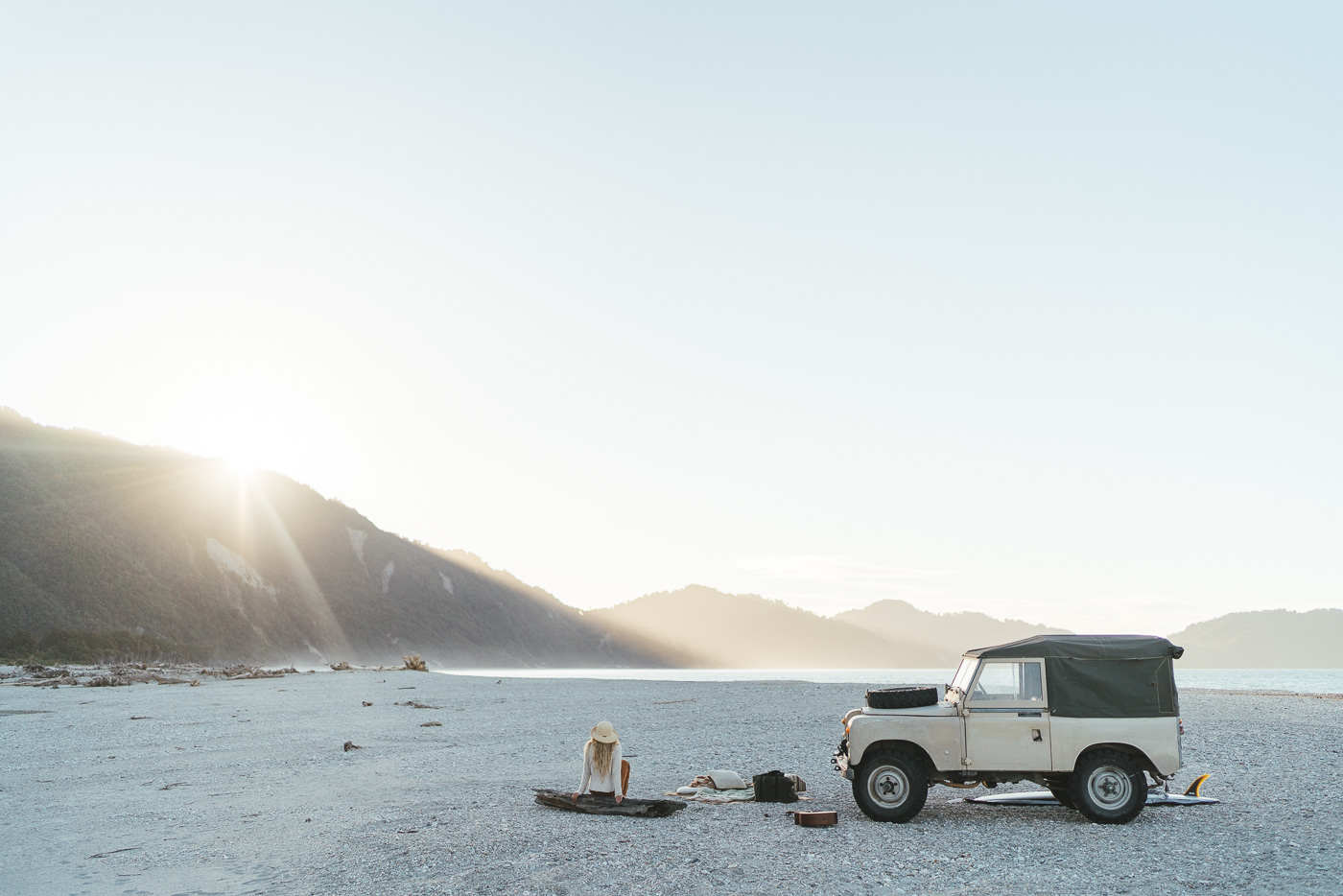 Jade Barclay at sunset beside the Series Land Rover in Jackson bay on the West coast of New Zealand. Captured by Sony Ambassador and Photographer Stefan Haworth