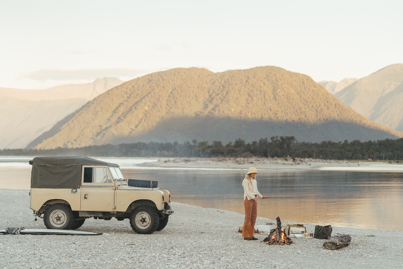 Jade Barclay watching the bonfire next to the Series Land rover in Haast on the west coast of new Zealand. Captured by Sony Ambassador and Photographer Stefan Haworth