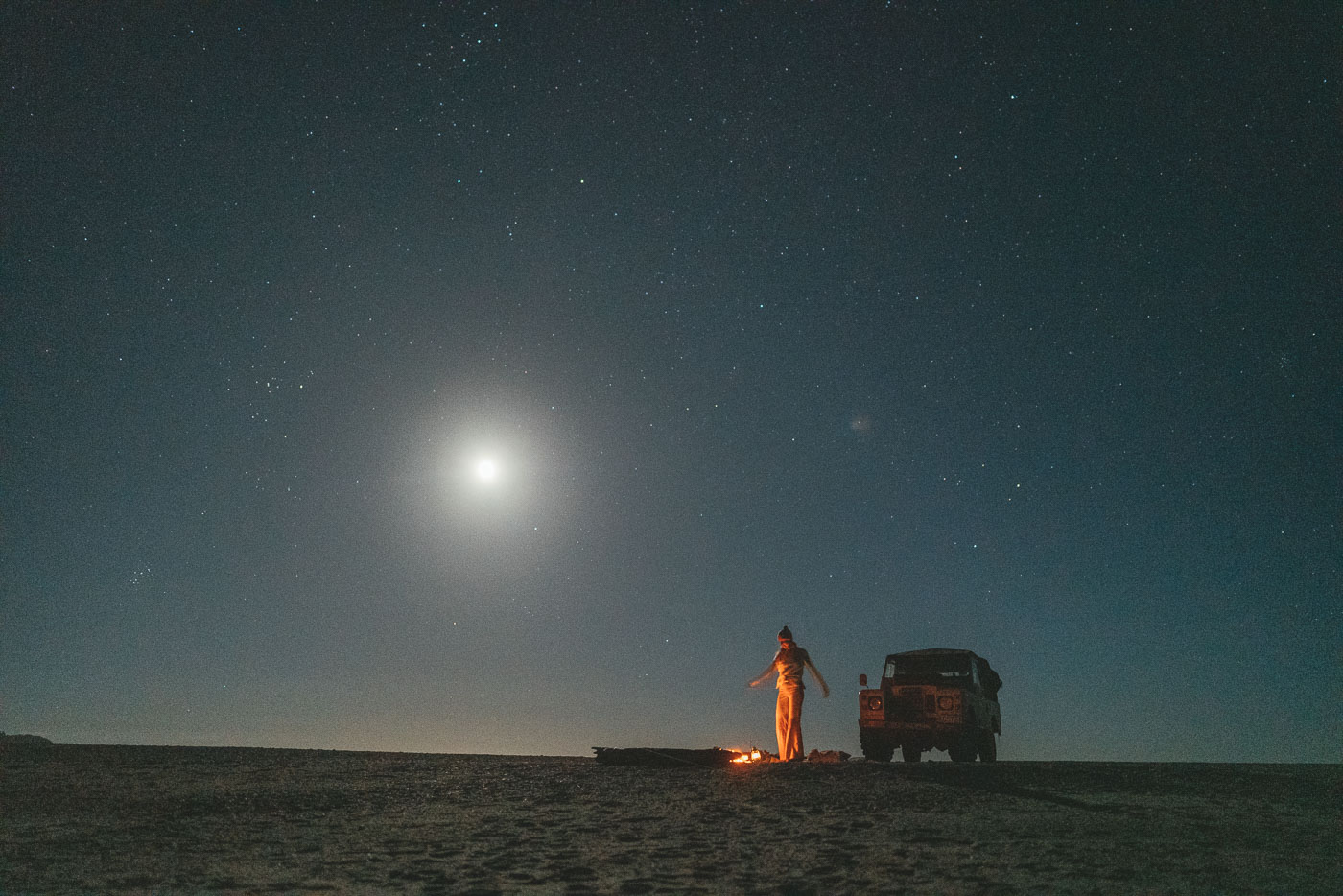 Jade Barclay dancing under a full moon next to the Series Land Rover on the West Coast of New Zealand. Captured by Sony Ambassador and Photographer Stefan Haworth