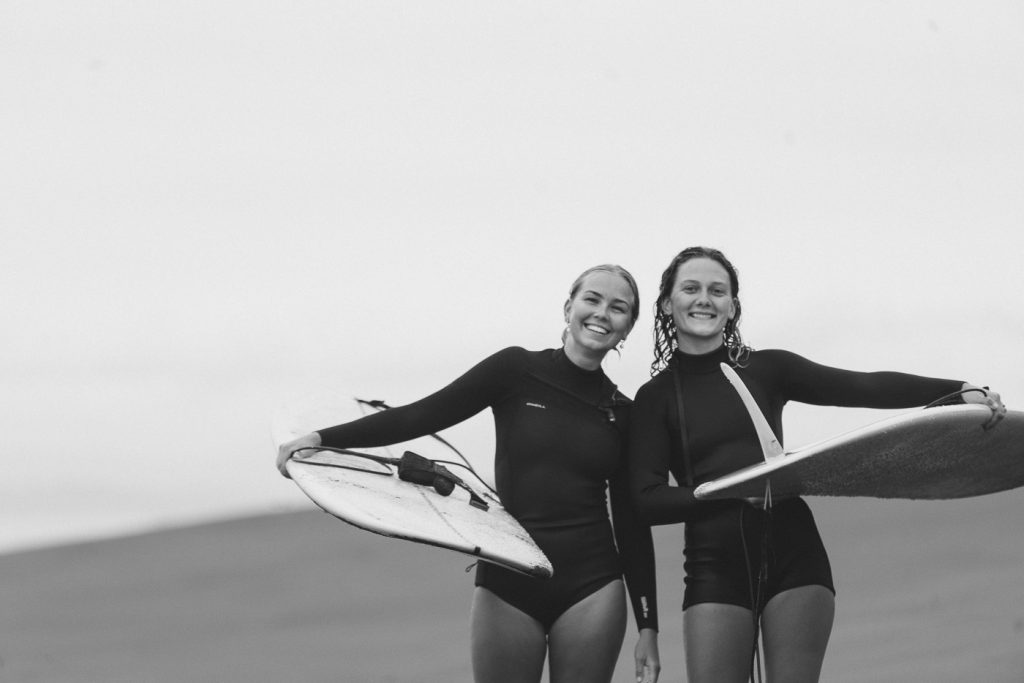 Moa Raud and Karin Falk in wetsuits after a surf at Mahia on the East Cape road trip of New Zealand