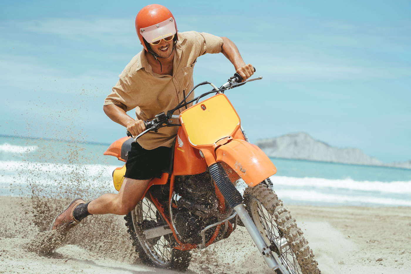 Jonty riding up the beach on the vintage motorbike. Captured by Adventure photographer Stefan Haworth