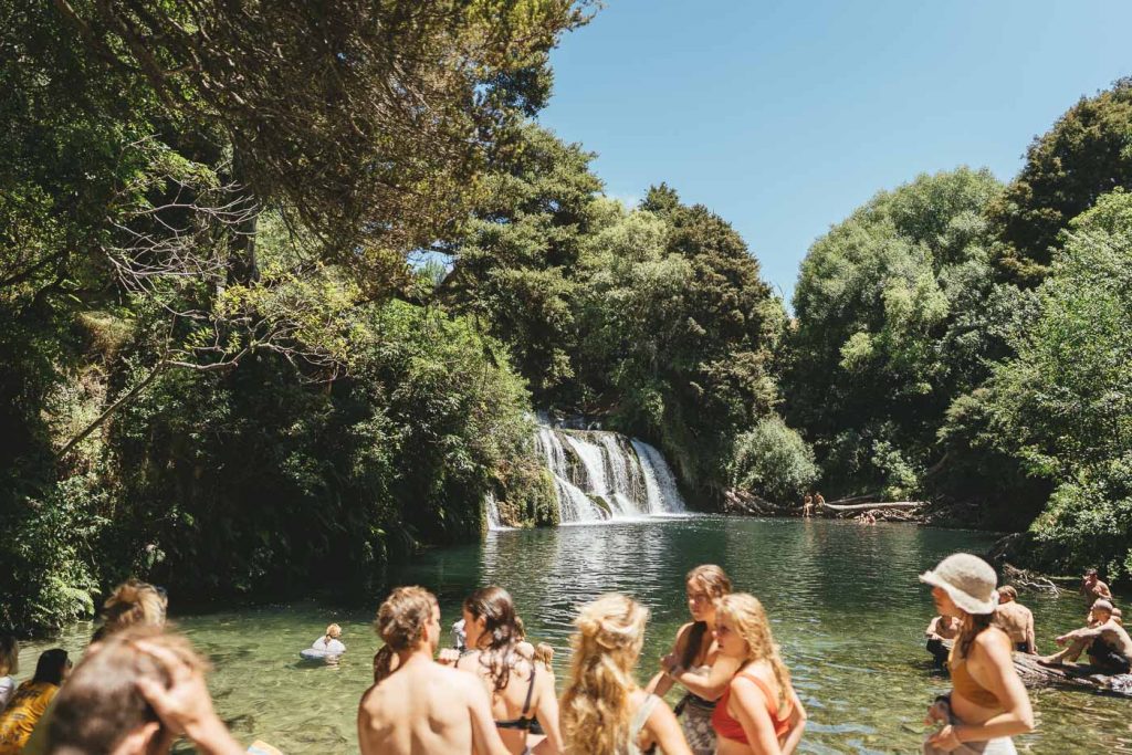 Crowds at Local havelock North waterfall during a break from Nestfest 2022 during a Roadtrip of New Zealand's east Cape. Captured by Photographer Stefan Haworth