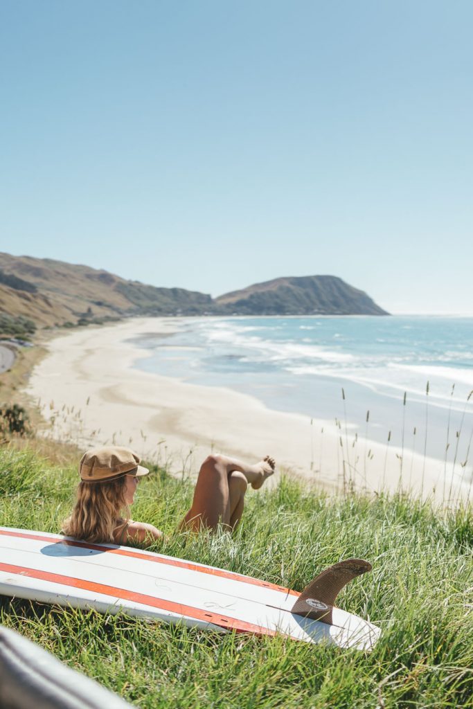 Jade Barclay watching over Wainui surf break after coming out of the Ocean to warm up. Captured by Adventure photographer Stefan Haworth