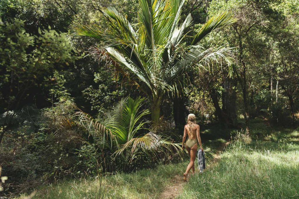 Jade Barclay Walking to a jungle waterfall on the East Cape road trip of New Zealand. Captured by photographer Stefan Haworth