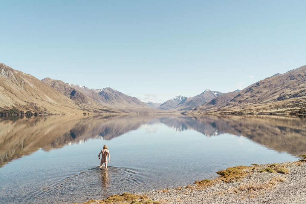 Joe Leeper skinning dipping in cold alpine lake of New Zealand