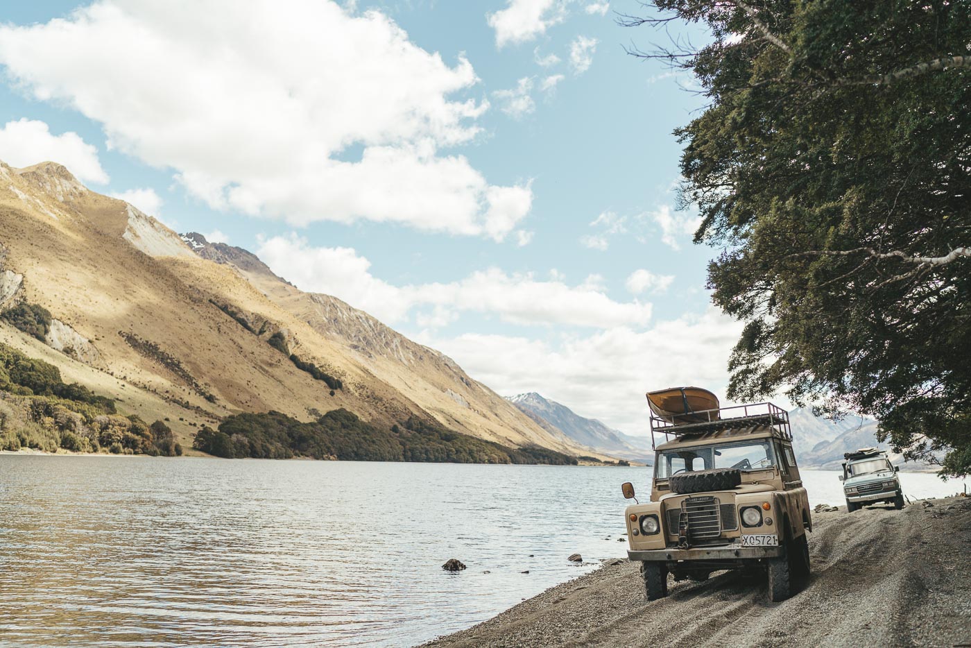 Series Land rover driving along alpine lake in Southern Alps of New Zealand. Captured by adventure Photographer Stefan Haworth