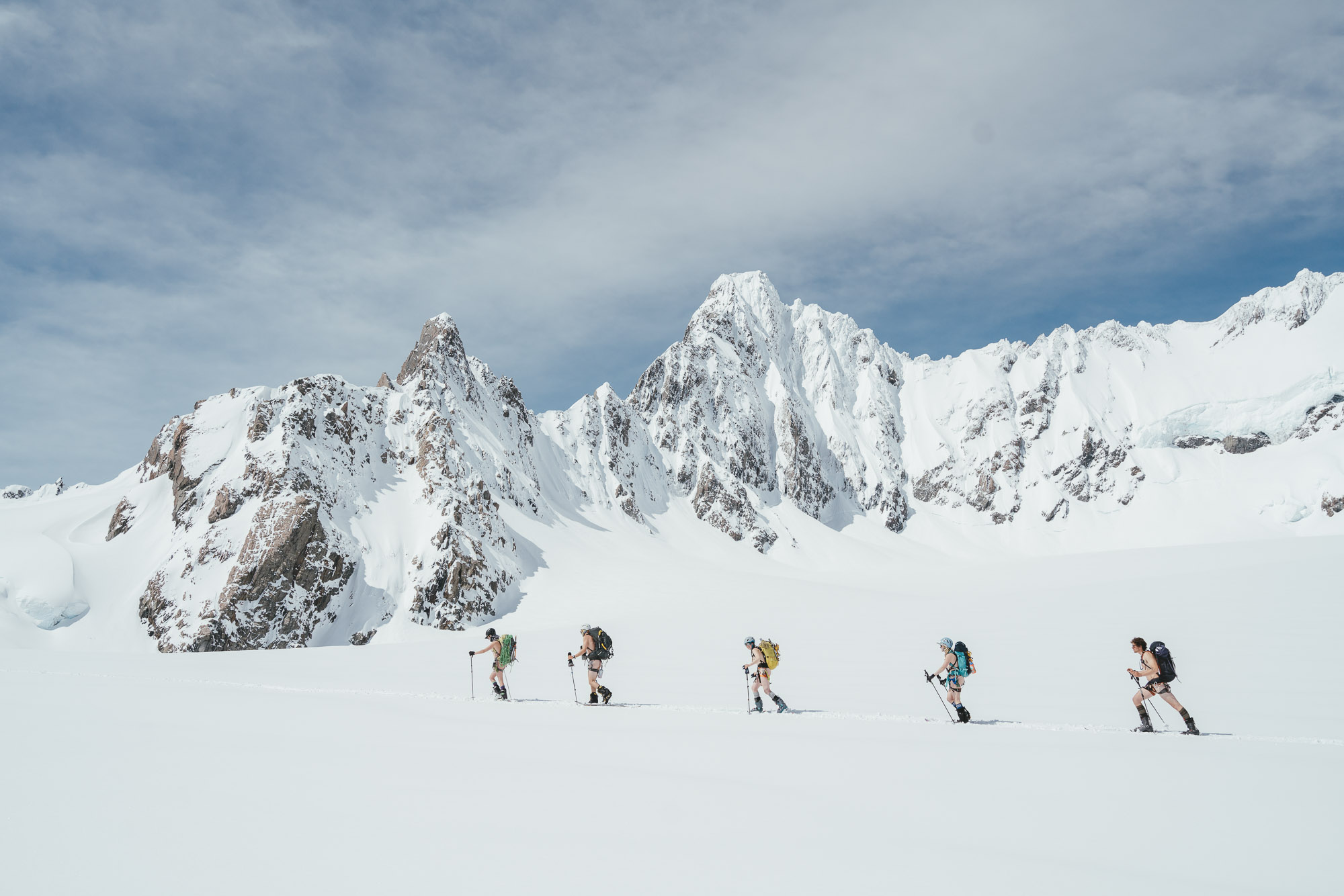 Backcountry alpinist travelling across the fox glacier naked with Douglas Peak, New Zealand