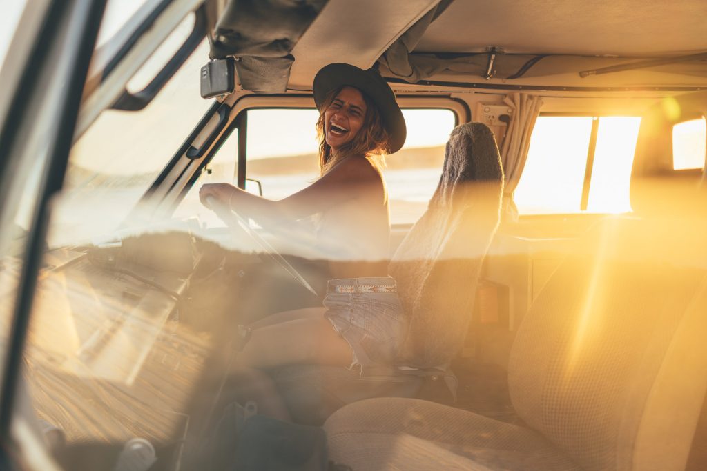 Alex Cohen driving Will and Bear van in Noosa Beach at sunset in Australia