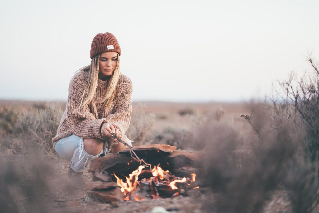 Jess tending to cooking over the campfire