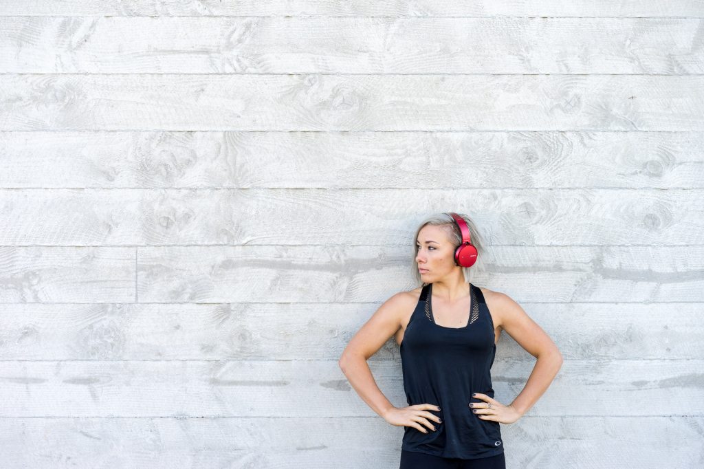 World Champion Australian cyclist Caroline Buchanan wearing Sony headphones against Concrete wall